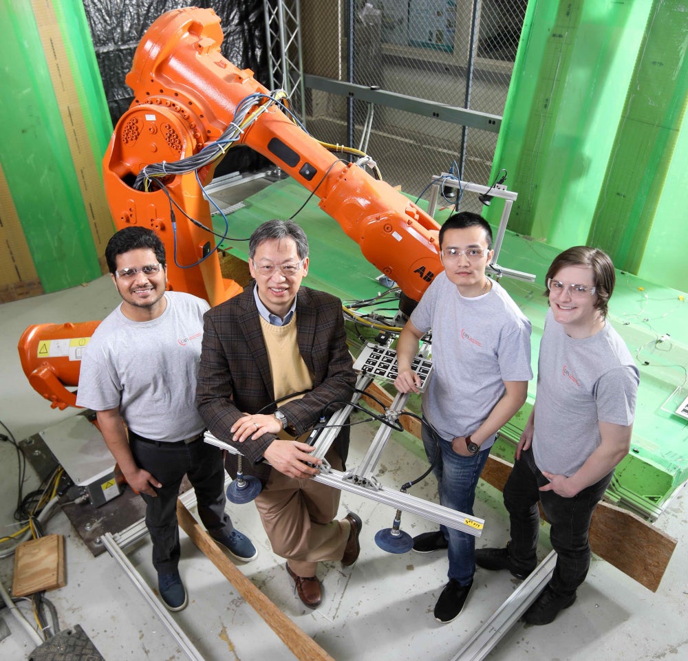 John Wen, Students, and Staff with Industrial Robot